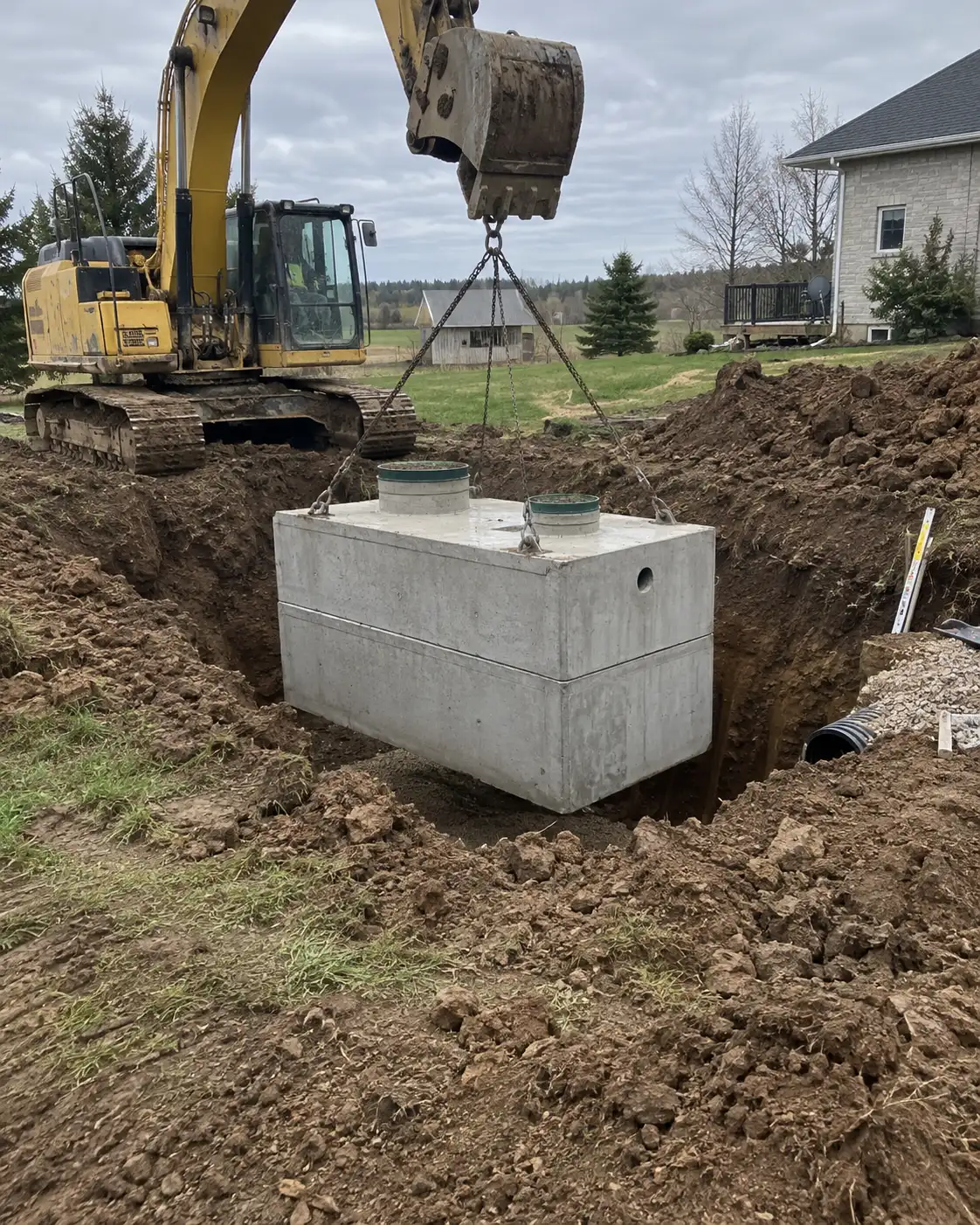 Septic tank installation with an excavator near Guelph