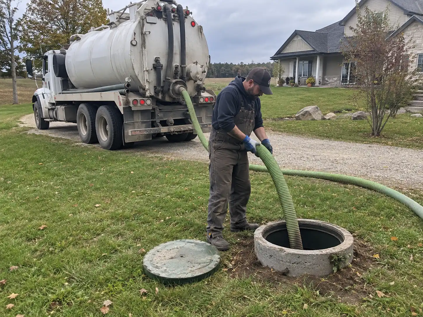 Septic truck pumping a septic tank at a home in Guelph