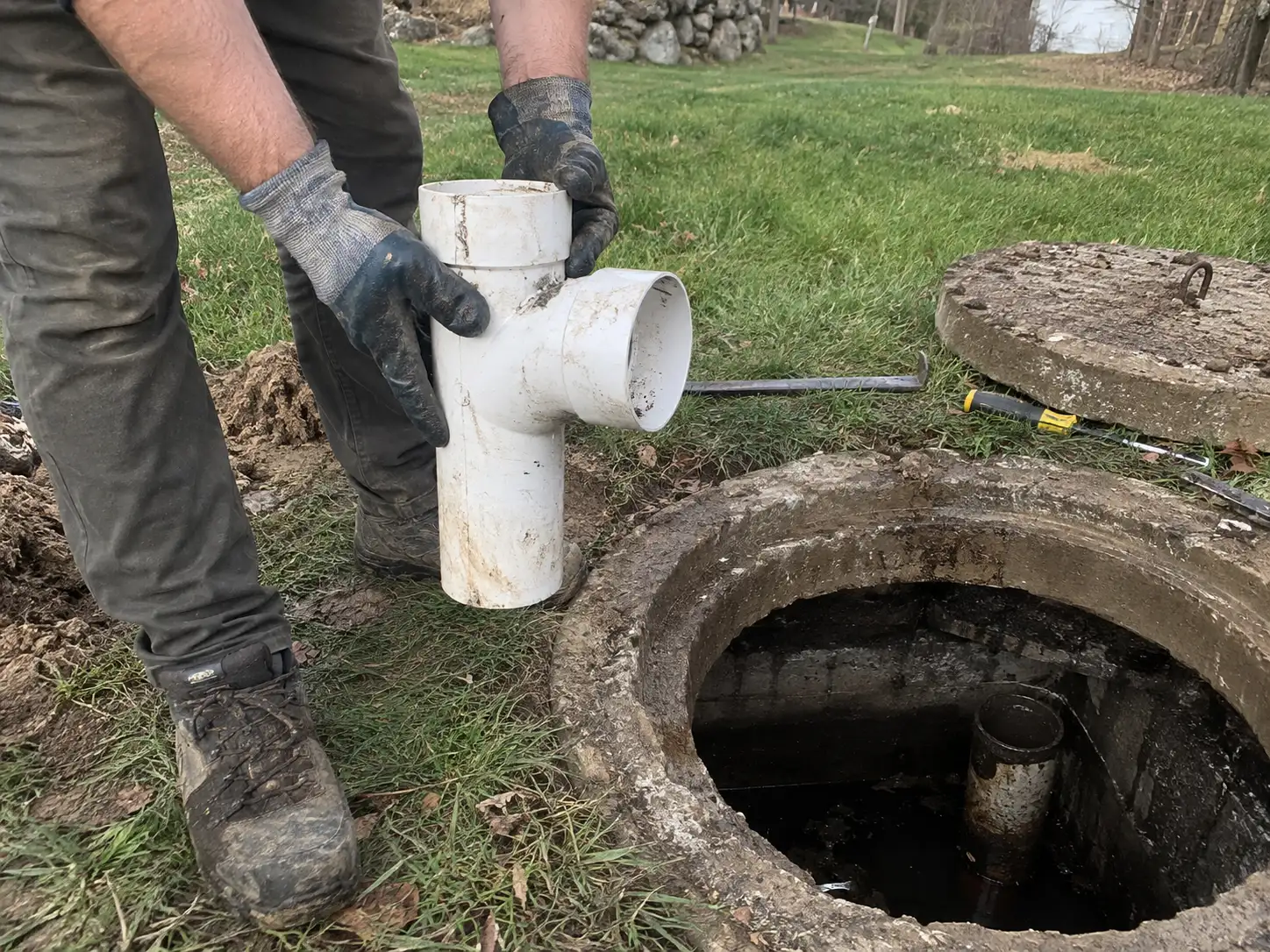 Technician installing a new septic tank baffle